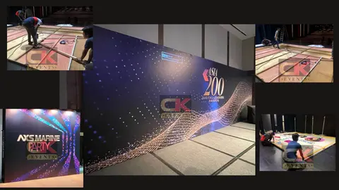 Wide printed awards backdrop with photographs of timber panel assembly