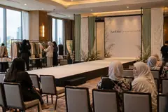 Naelofar fashion show design reference with modest-fashion presentation and draped backdrop