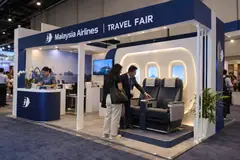Malaysia Airlines travel fair design reference with cabin-seat travel experience corner and booking desk